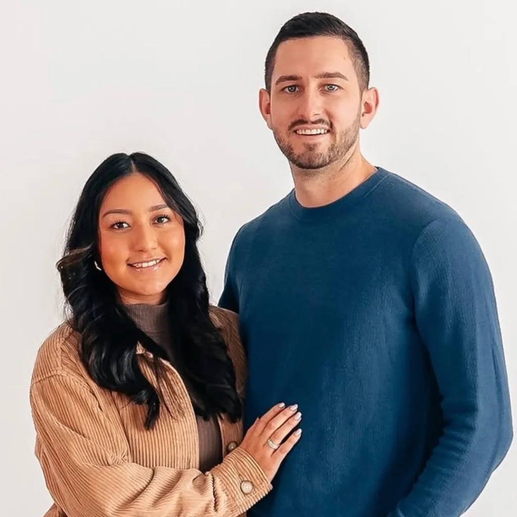 Aaron and Stephanie Andrew against a white studio background