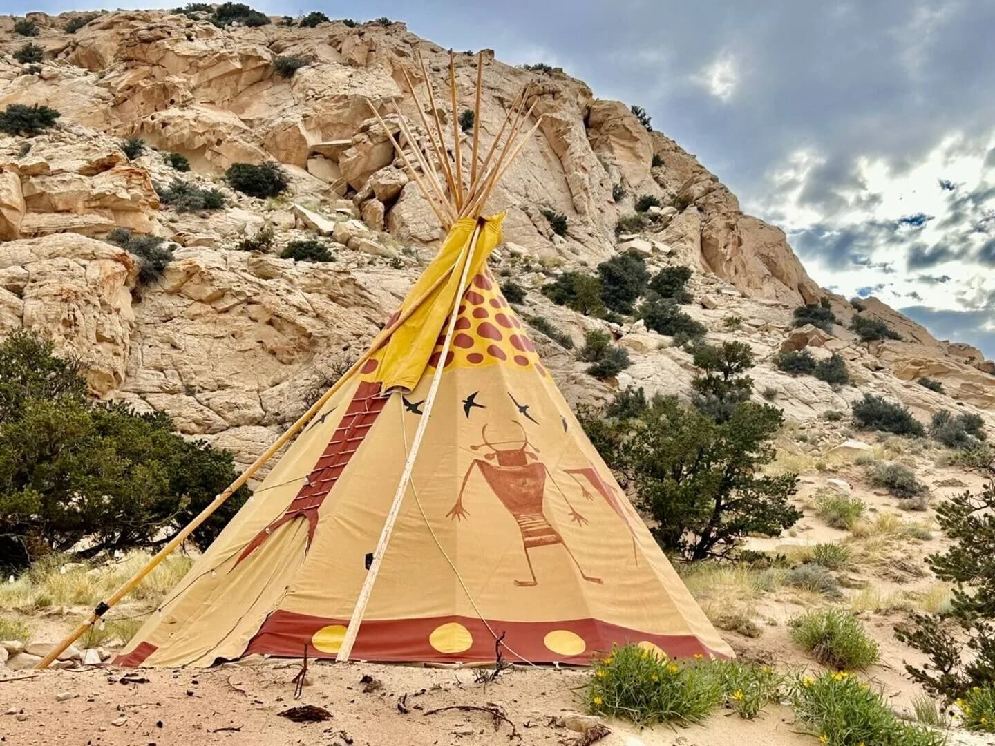 The Shaman tipi against the white sandstone cliff