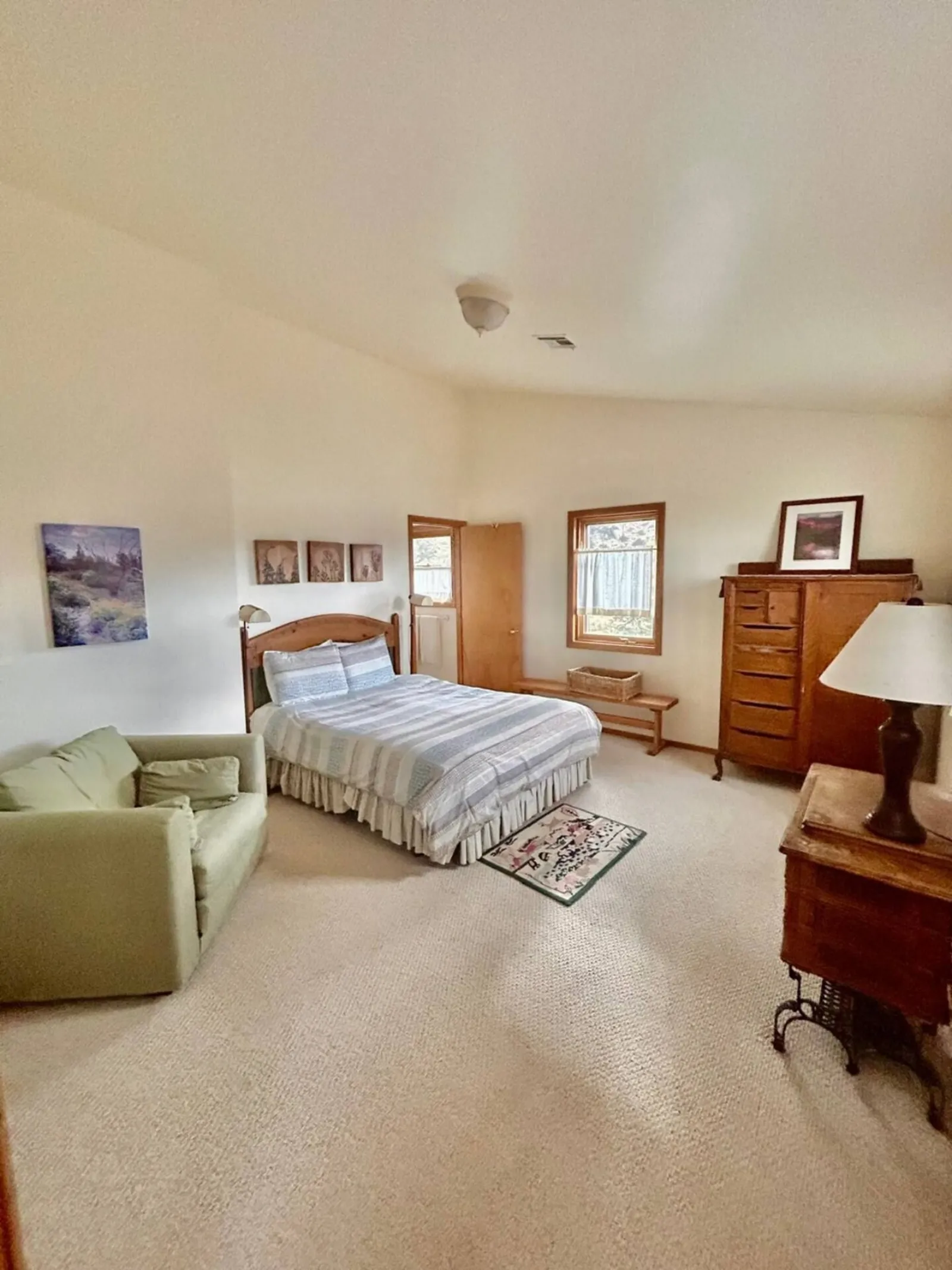 A bedroom in The Lodge with a single bed, armchair and writing desk