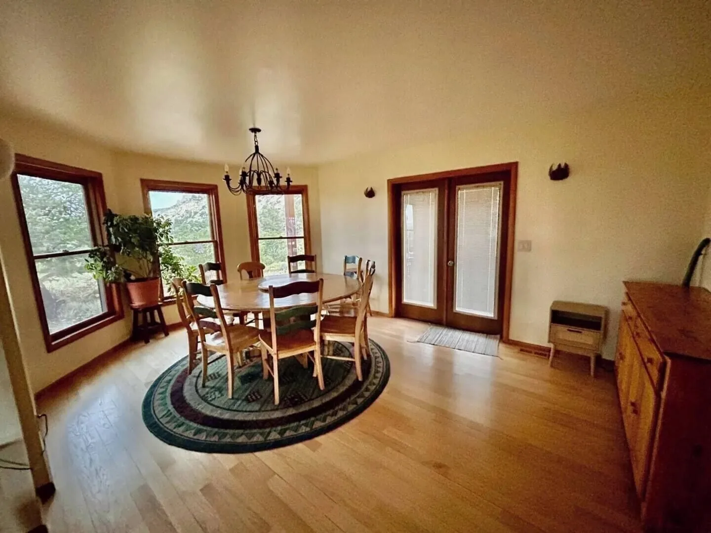 The Lodge's dining area, with a round wooden table under a chandelier