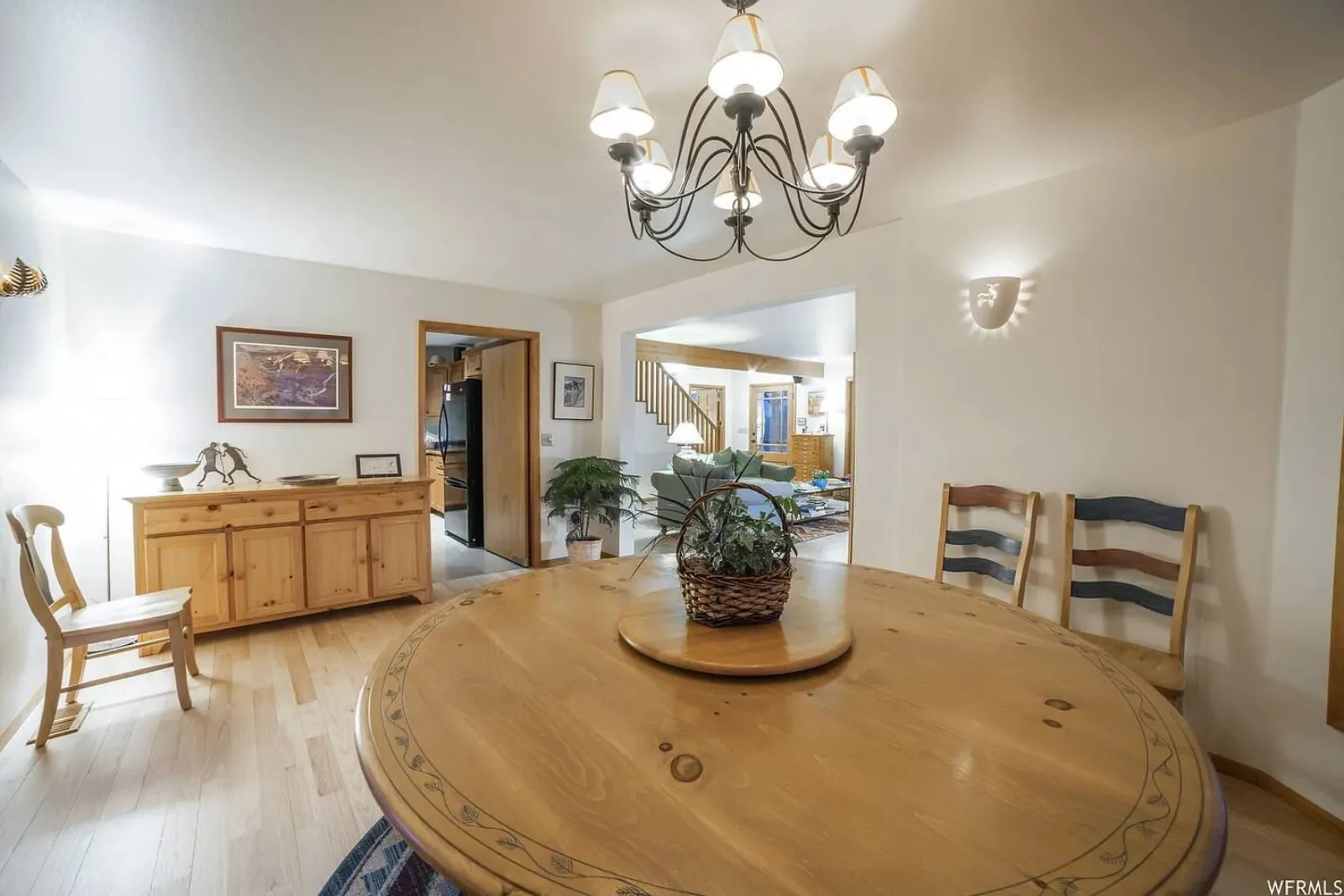 The Lodge's dining area, with a round wooden table under a chandelier